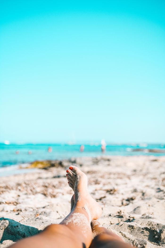 Offerings Barefoot relaxation on a sunny beach in Spain, enjoying sand and sea.